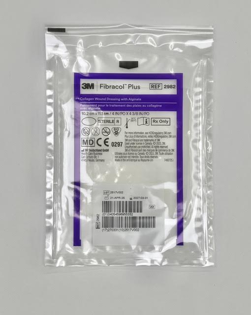 An individual sterile peel pouch packet of a 3M Fibracol Plus 2982 collagen and alginate wound dressing pad.