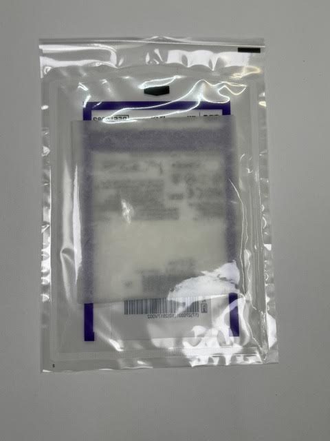 Close up view of the porous texture of an unboxed Fibracol Plus 2982 collagen alginate absorbent dressing pad.